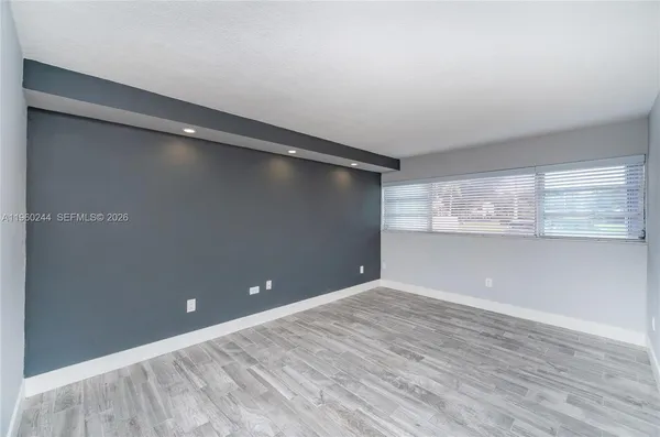 a view of an empty room with a window