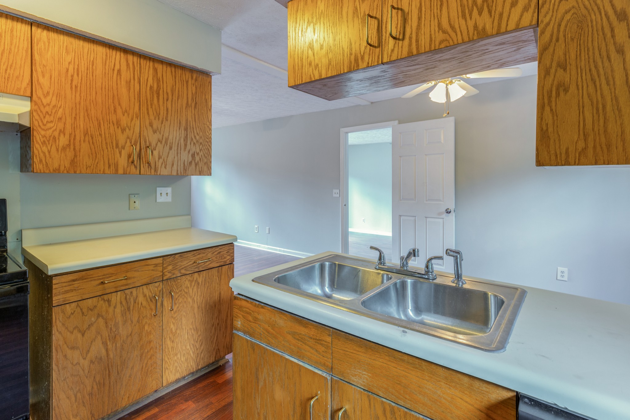 229 Manzano Road Madison, TN 37115 - Photo 11 of 26 a kitchen with a sink cabinets and a wooden floor
