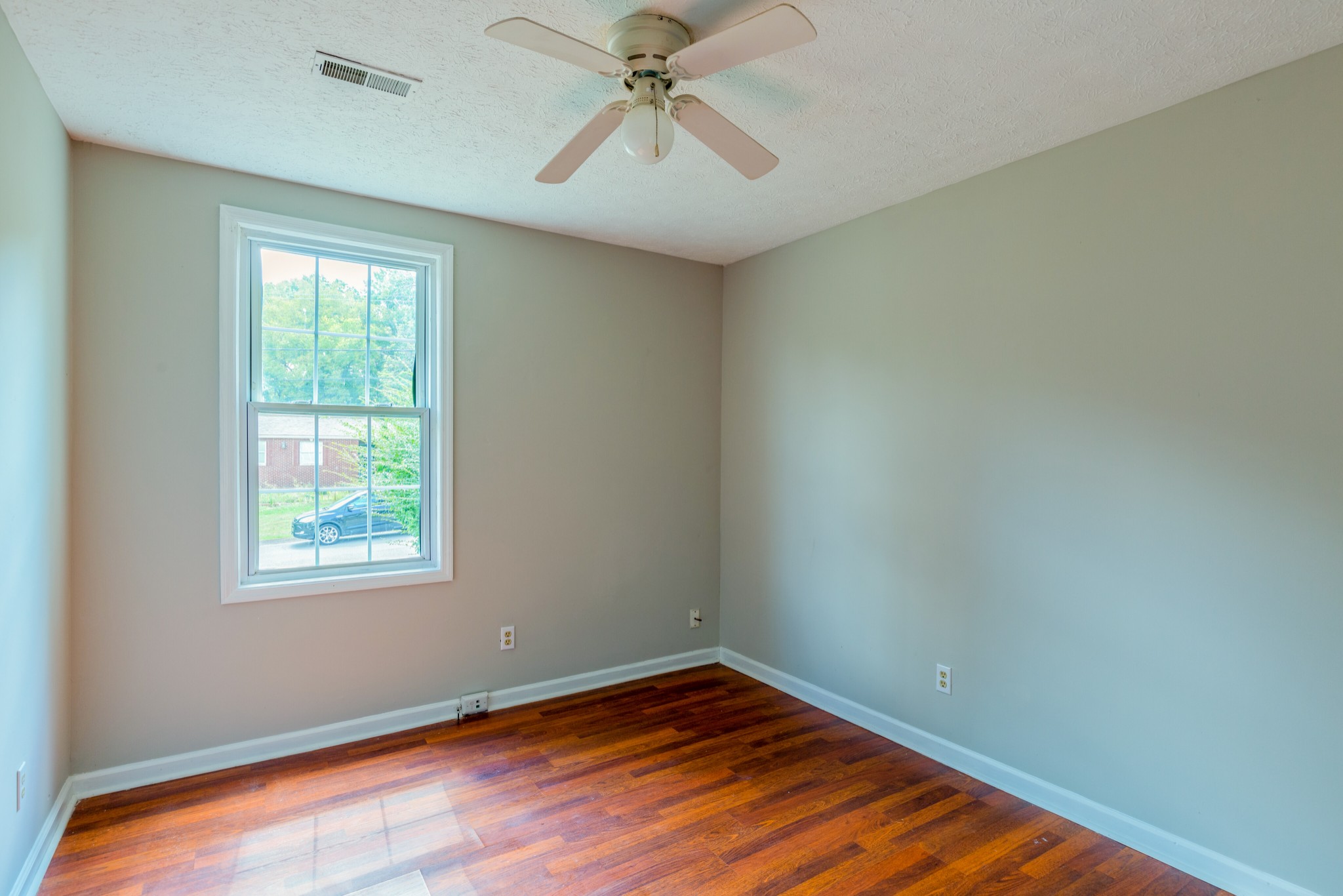 229 Manzano Road Madison, TN 37115 - Photo 14 of 26 a view of an empty room with window and wooden floor