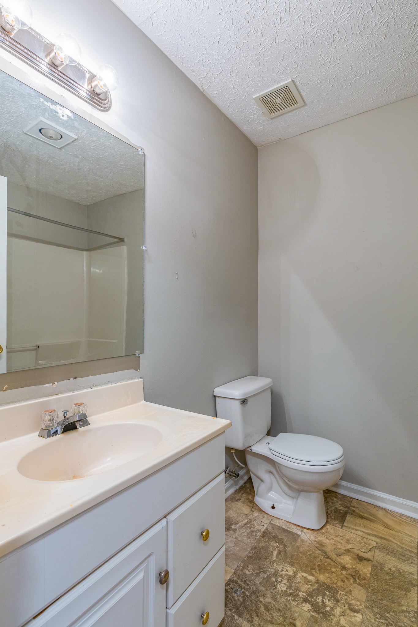 229 Manzano Road Madison, TN 37115 - Photo 16 of 26 a bathroom with a granite countertop toilet a sink and a mirror