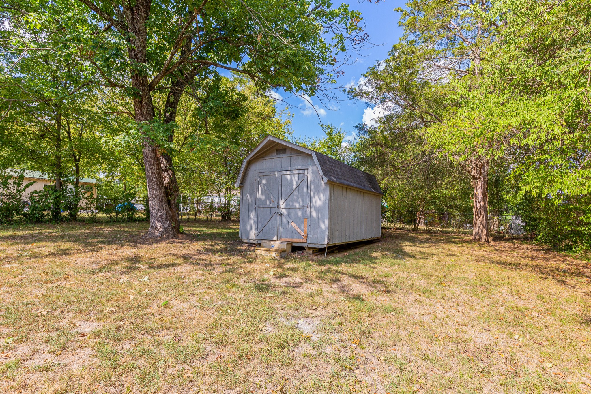 229 Manzano Road Madison, TN 37115 - Photo 26 of 26 a backyard of a house with wooden fence and large trees