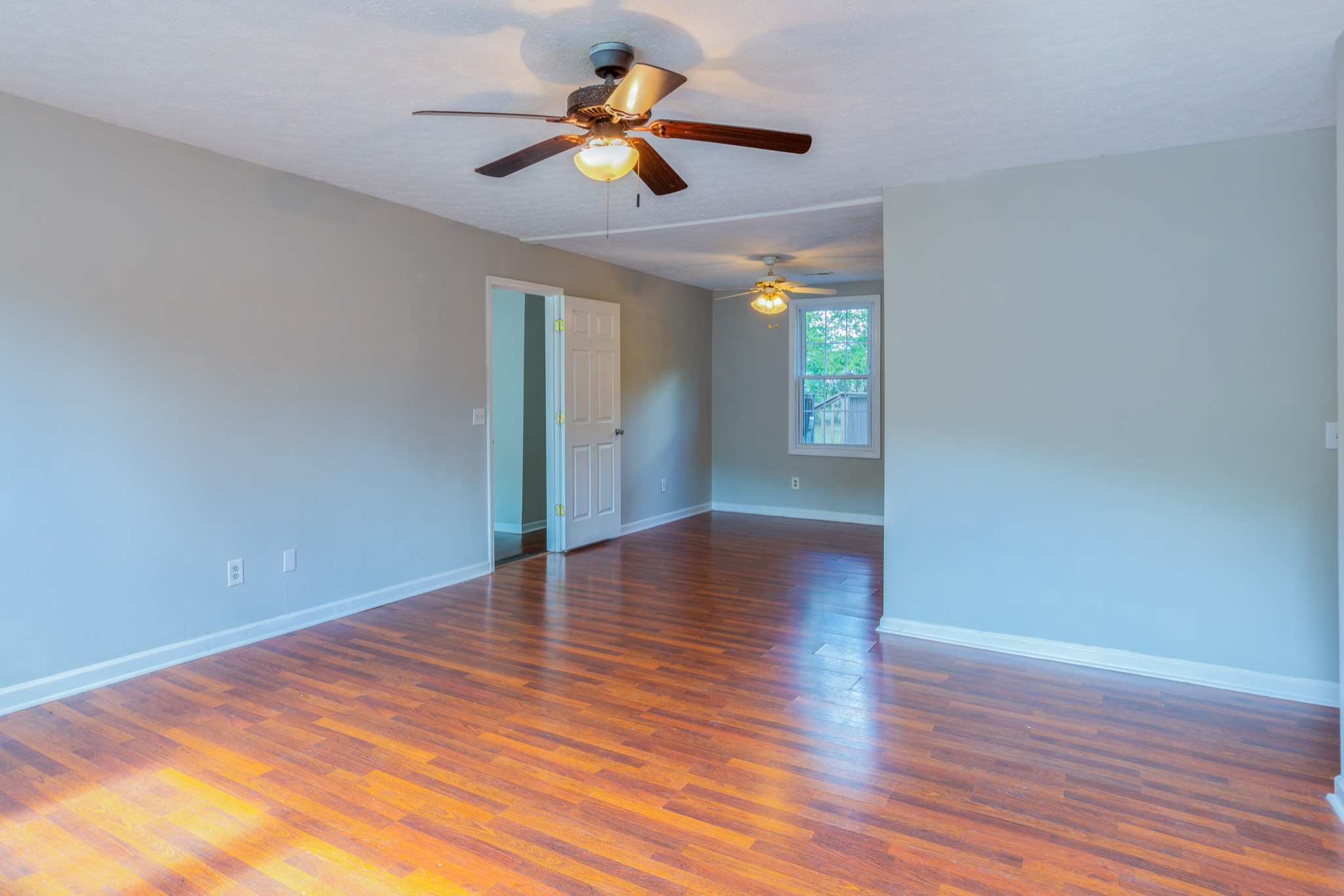 229 Manzano Road Madison, TN 37115 - Photo 5 of 26 a view of an empty room with window and wooden floor