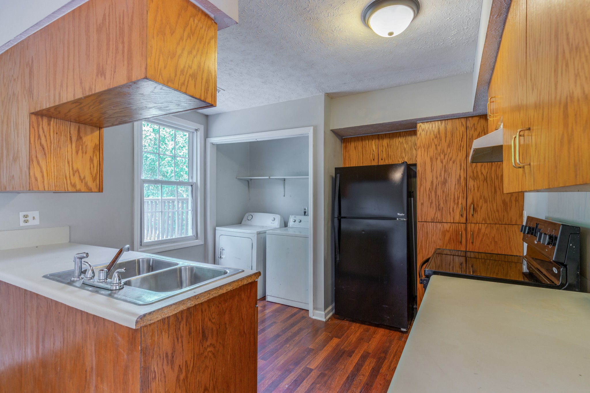 229 Manzano Road Madison, TN 37115 - Photo 9 of 26 a kitchen with granite countertop a sink a counter space and stainless steel appliances