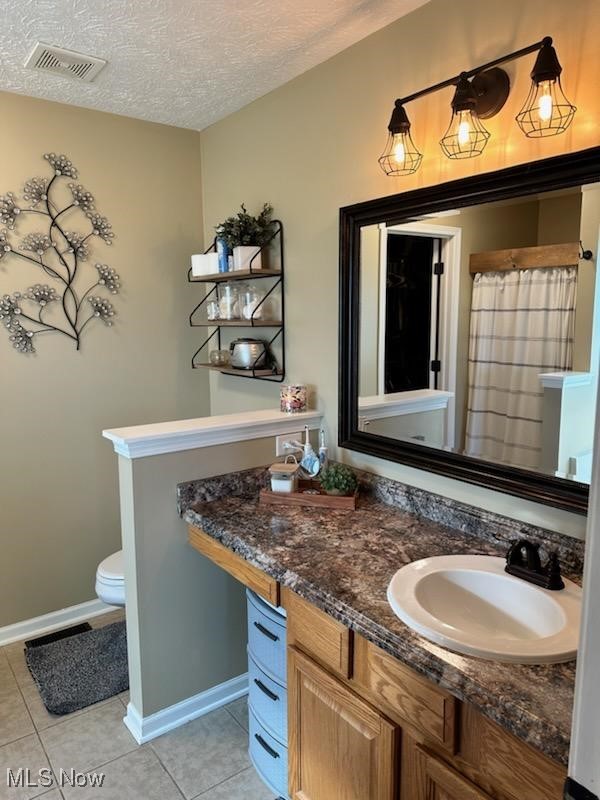 2761 Omega Road Greenwich, OH 44837 - Photo 42 of 50 Bathroom with vanity, a textured ceiling, toilet, and tile patterned flooring