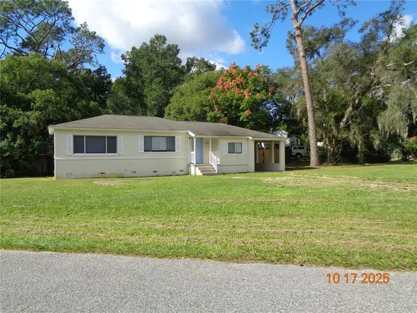 a front view of house with yard and green space