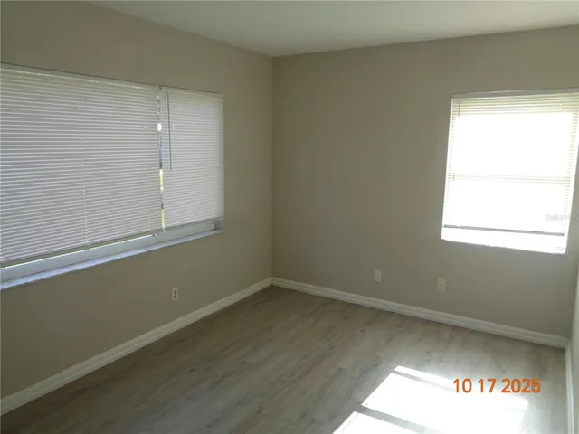 an empty room with wooden floor
