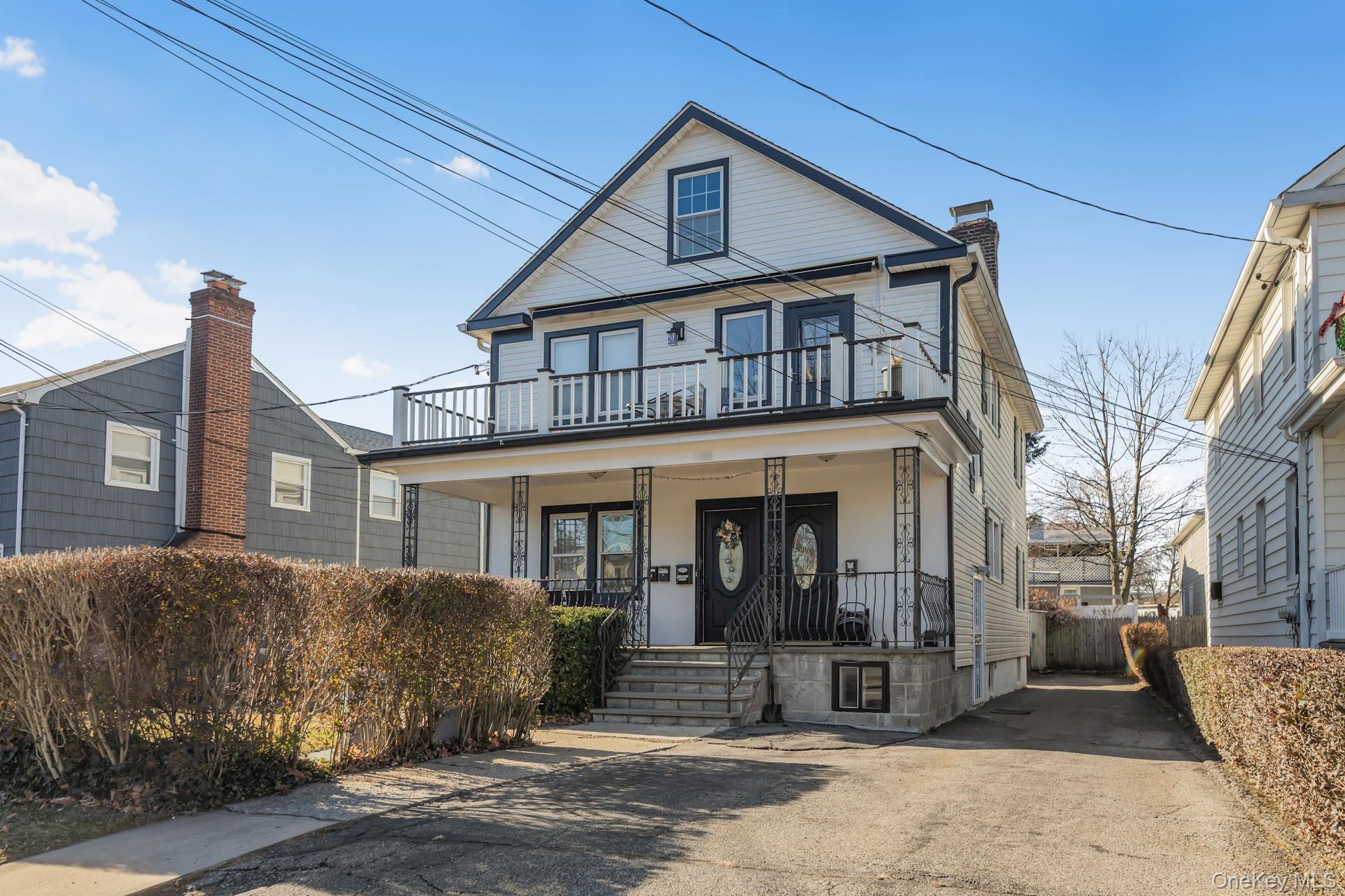 168 Stephenson Boulevard New Rochelle, NY 10801 - Photo 1 of 21 View of front facade featuring covered porch and a chimney