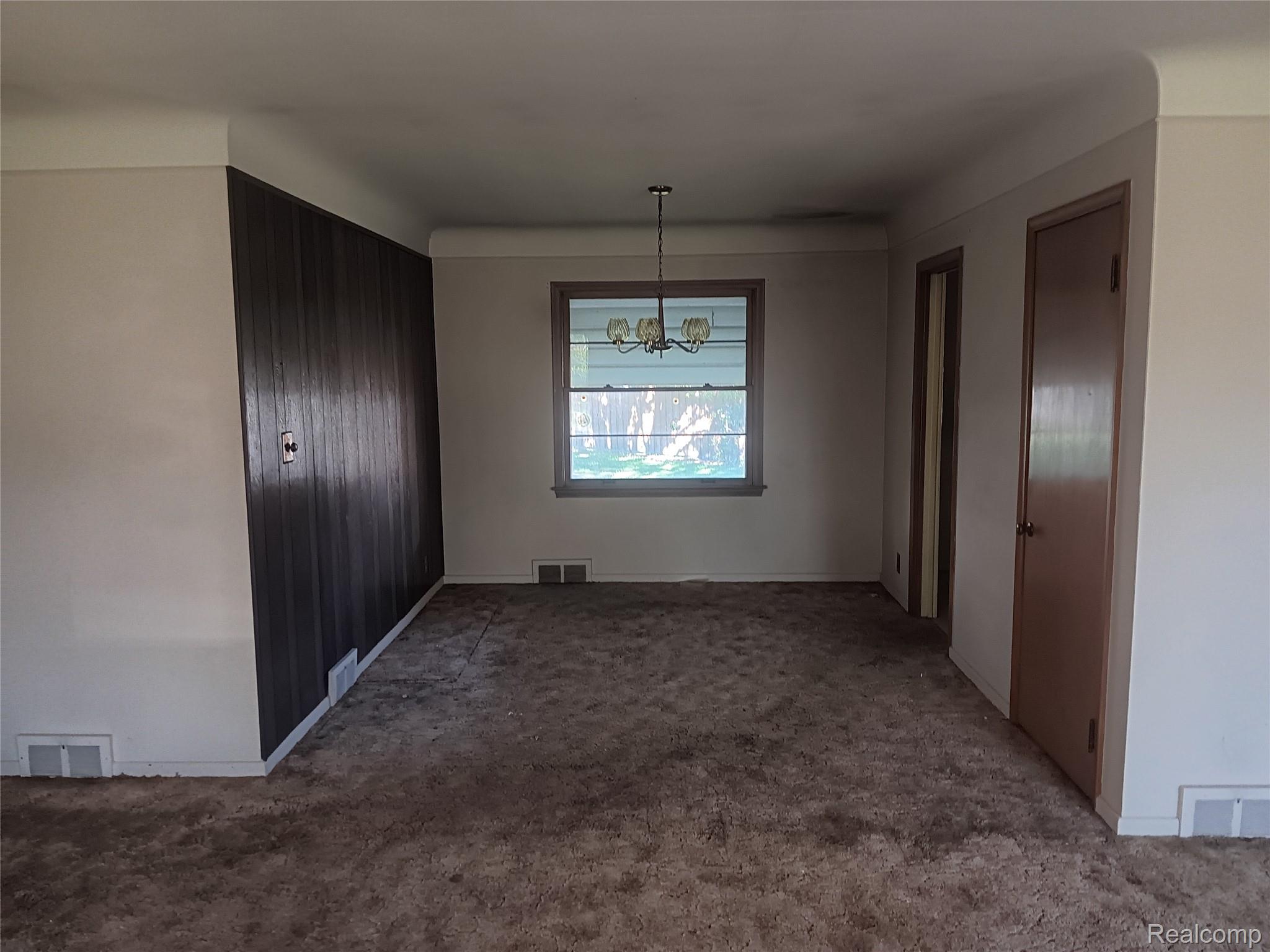 967 Washington Road Grosse Pointe, MI 48230 - Photo 3 of 15 Unfurnished dining area with carpet floors and hanging lights