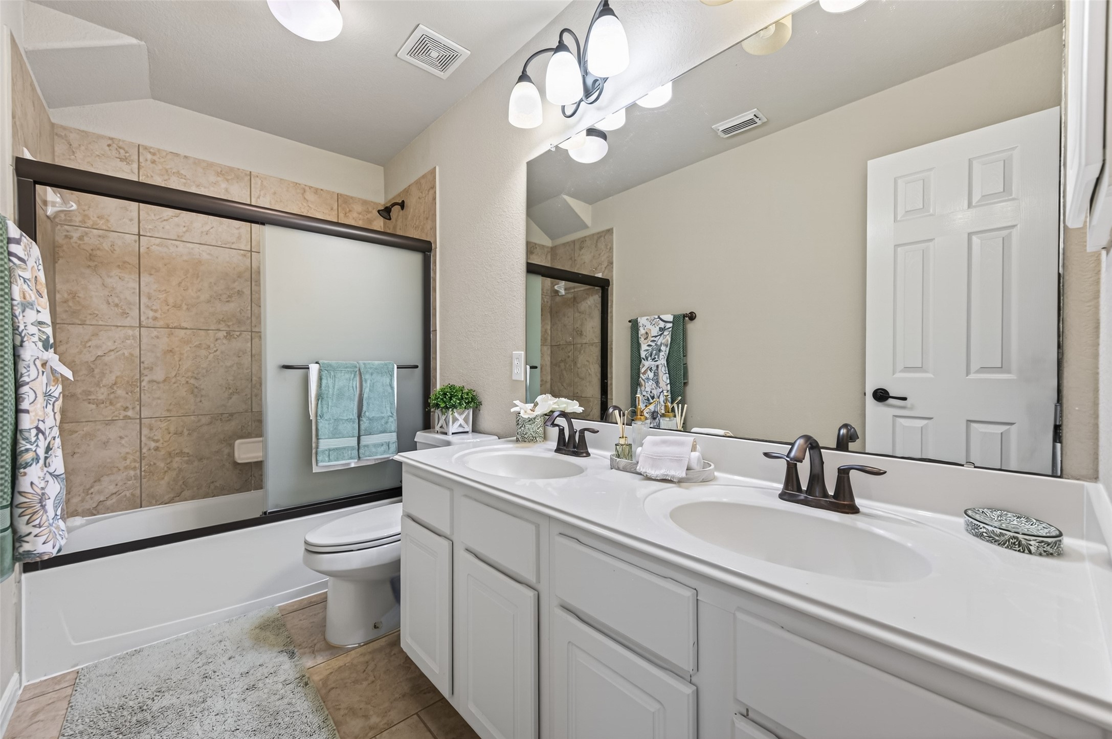 155 Rocky Point Drive Spring, TX 77389 - Photo 22 of 28 a bathroom with a double vanity sink mirror and toilet