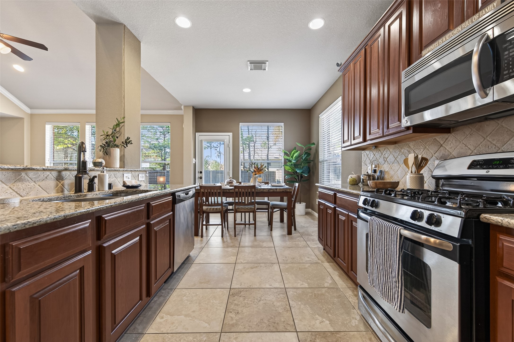 155 Rocky Point Drive Spring, TX 77389 - Photo 8 of 28 a kitchen with stainless steel appliances granite countertop a stove a sink and a microwave
