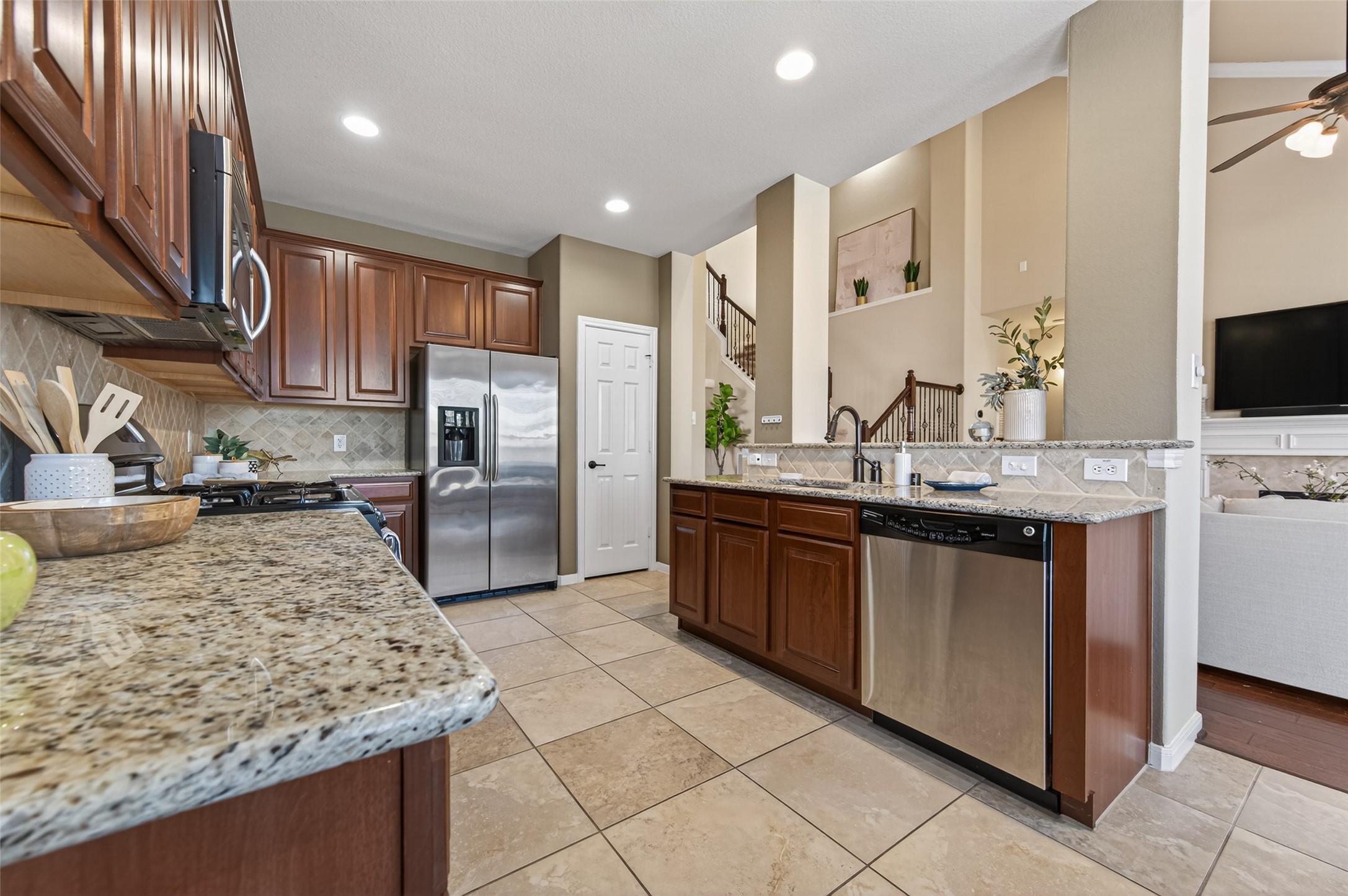 155 Rocky Point Drive Spring, TX 77389 - Photo 9 of 28 a kitchen with stainless steel appliances granite countertop a sink stove and refrigerator