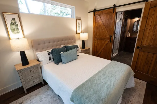 a bedroom with a bed and a mirror