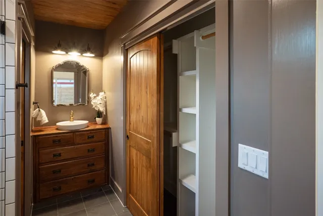 a bathroom with a mirror and a shower