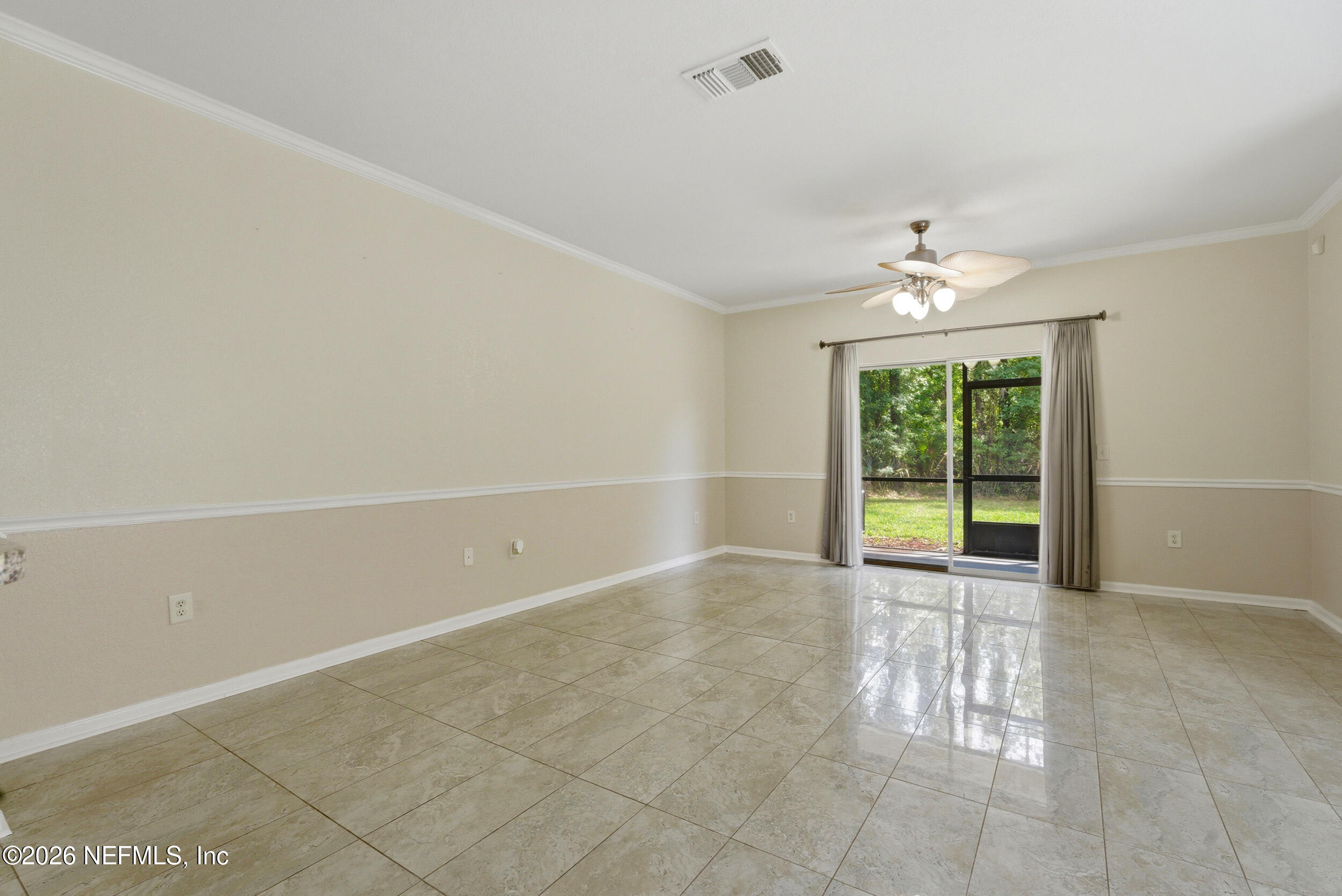 10200 Belle Rive Boulevard, Unit 4608 Jacksonville, FL 32256 - Photo 5 of 55 an empty room with floor to ceiling windows and chandelier fan