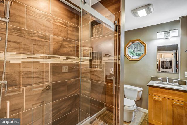 a bathroom with a toilet sink and shower