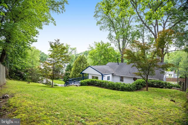 a aerial view of a house next to a big yard and large trees