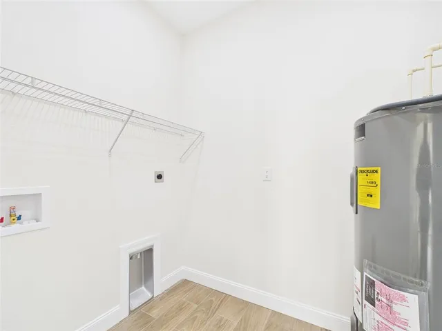 a view of storage and utility room with wooden floor