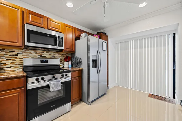 a kitchen with stainless steel appliances a stove a microwave and a refrigerator