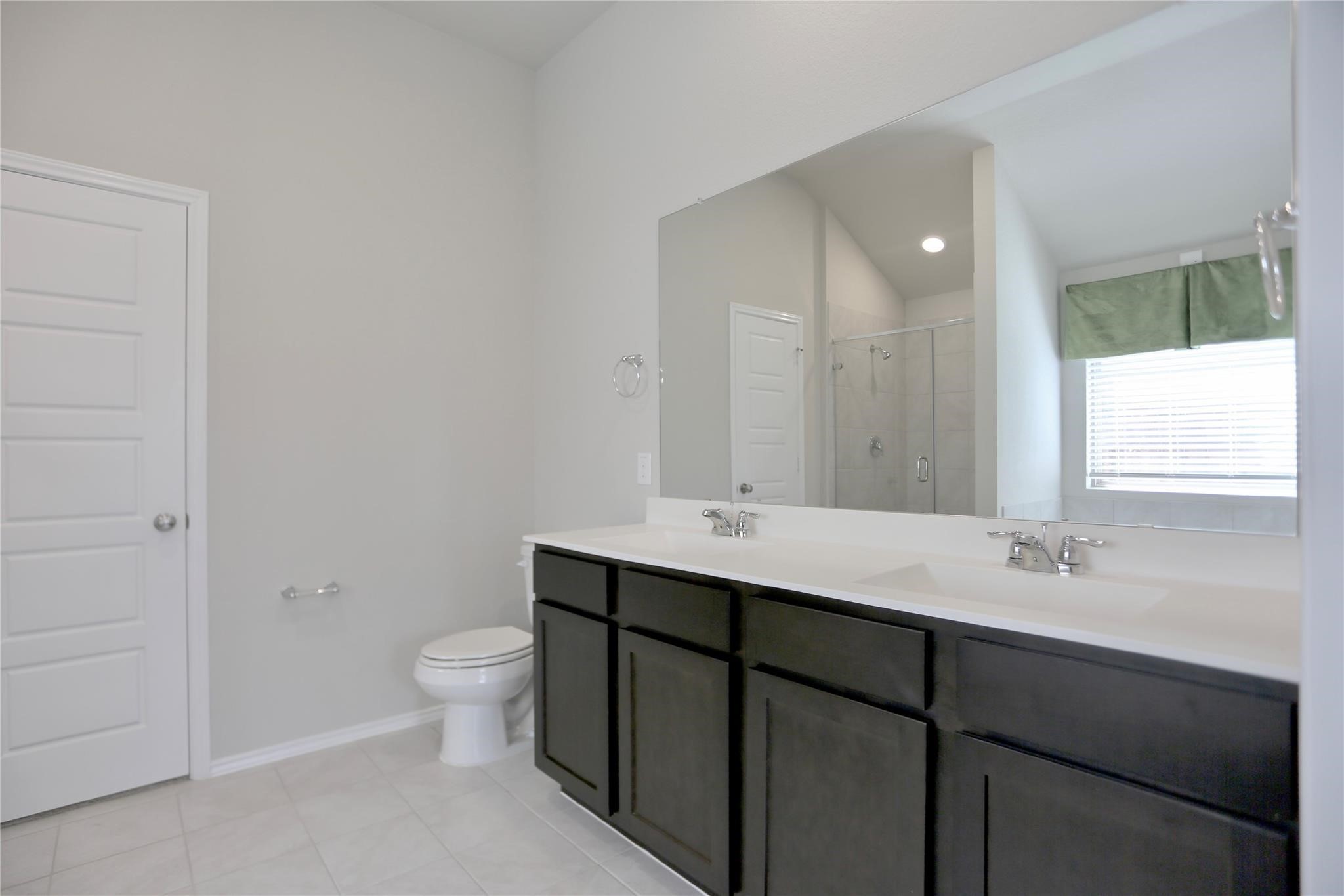 2123 Santa Ana Way Baytown, TX 77523 - Photo 12 of 20 a bathroom with a toilet sink and mirror