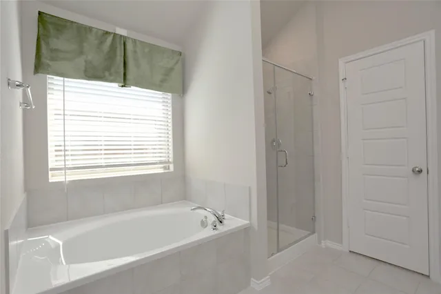 a bathroom with a bathtub and a shower