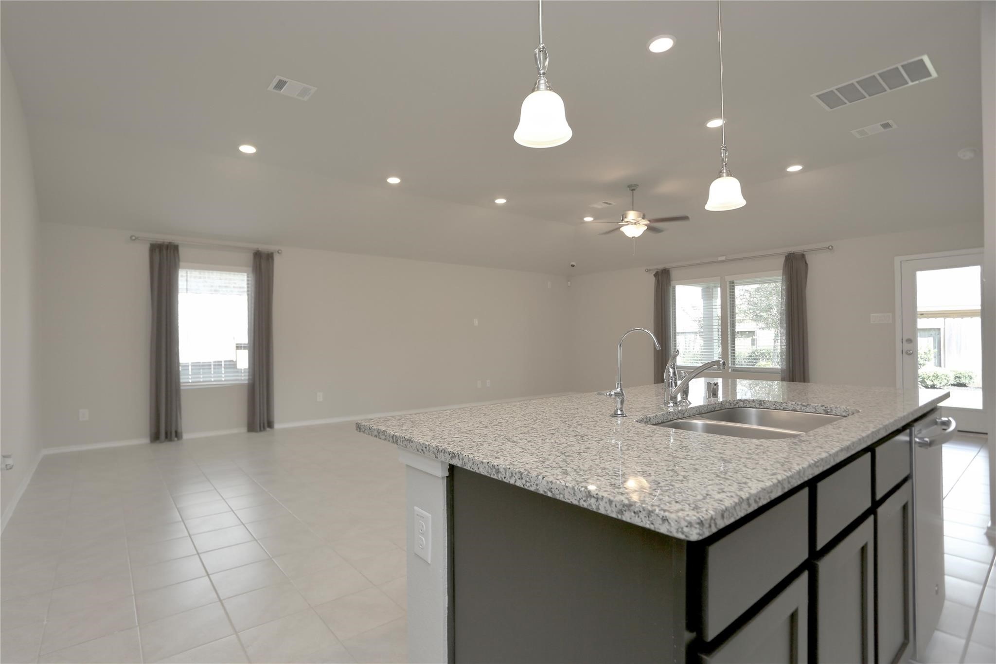 2123 Santa Ana Way Baytown, TX 77523 - Photo 6 of 20 a kitchen with granite countertop kitchen island a sink appliances and a counter space