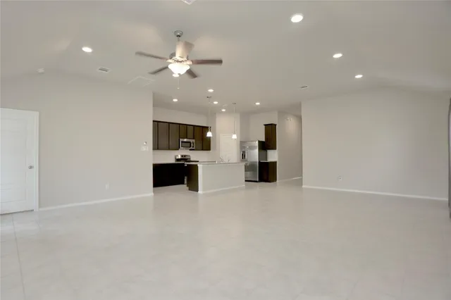 a view of kitchen with refrigerator and microwave