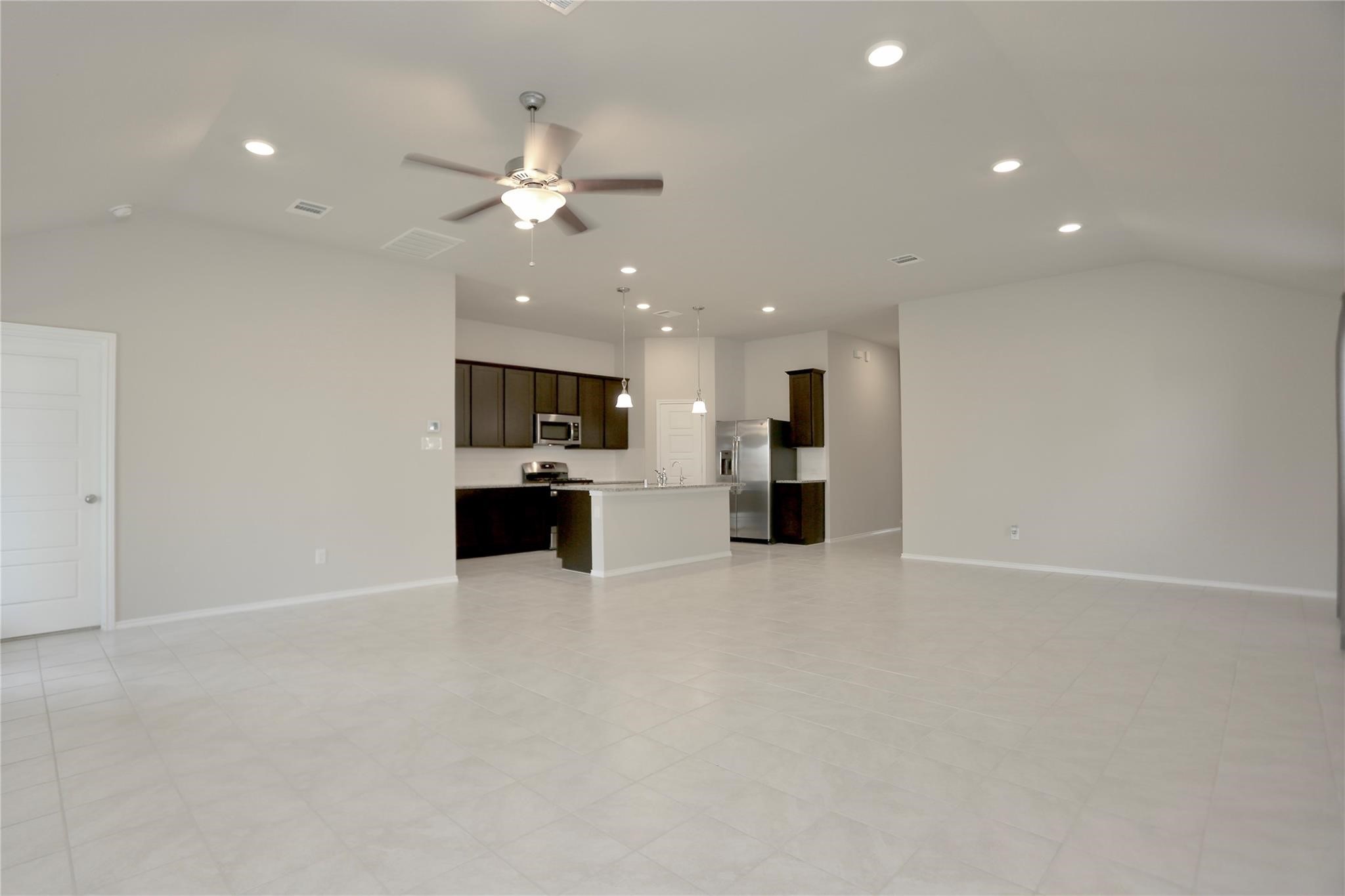 2123 Santa Ana Way Baytown, TX 77523 - Photo 7 of 20 a view of kitchen with refrigerator and microwave