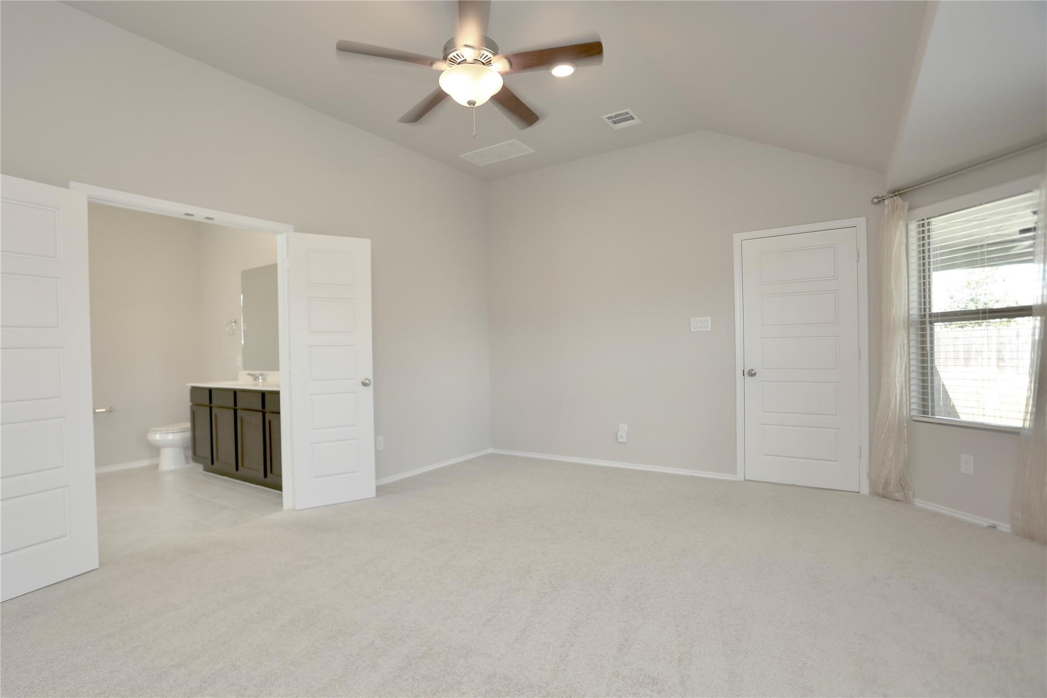 2123 Santa Ana Way Baytown, TX 77523 - Photo 9 of 20 an empty room with chandelier fan and windows