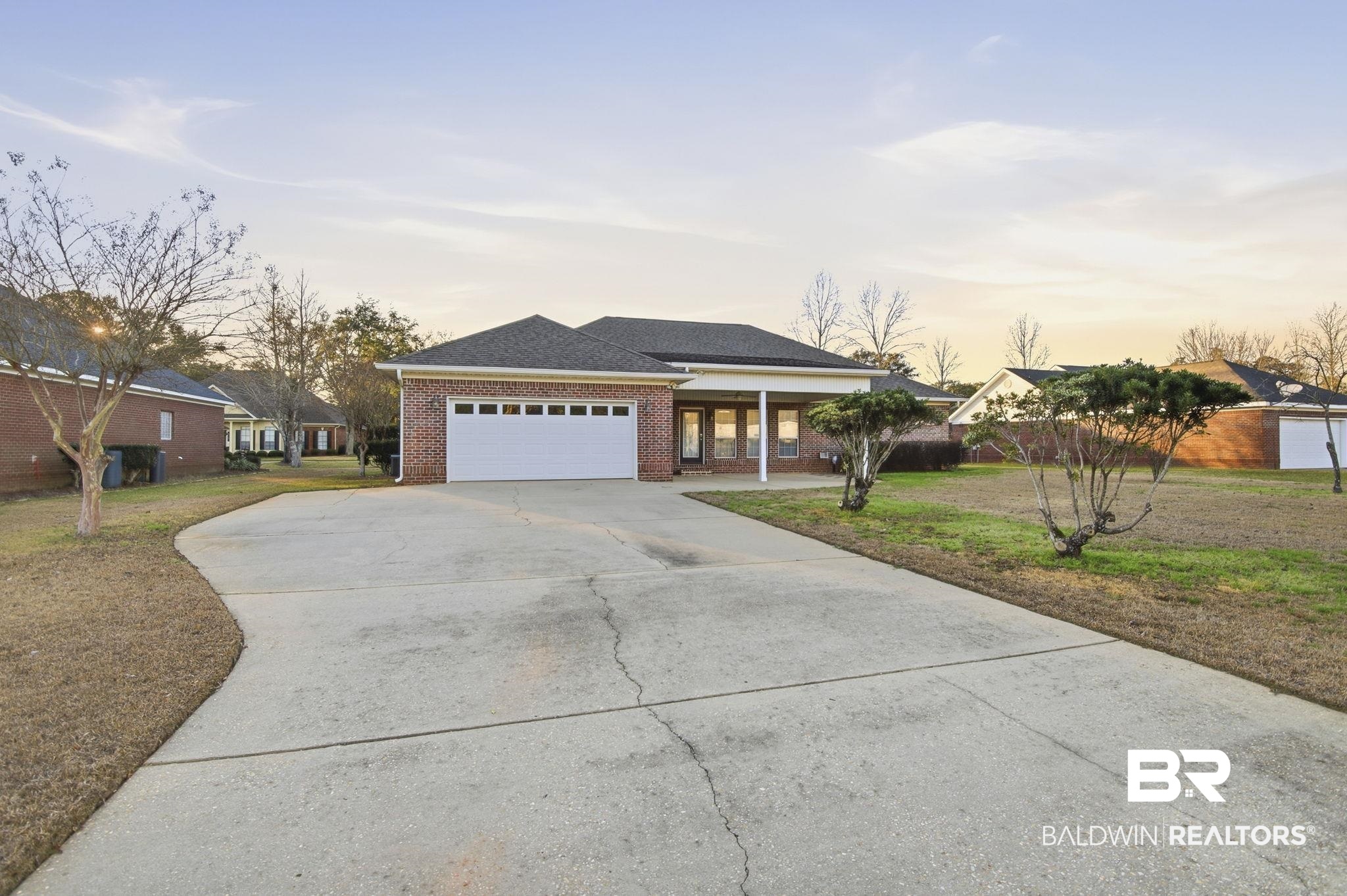 29634 St George Street Daphne, AL 36526 - Photo 43 of 47 Ranch-style home featuring brick siding, concrete driveway, a lawn, a garage, and a shingled roof