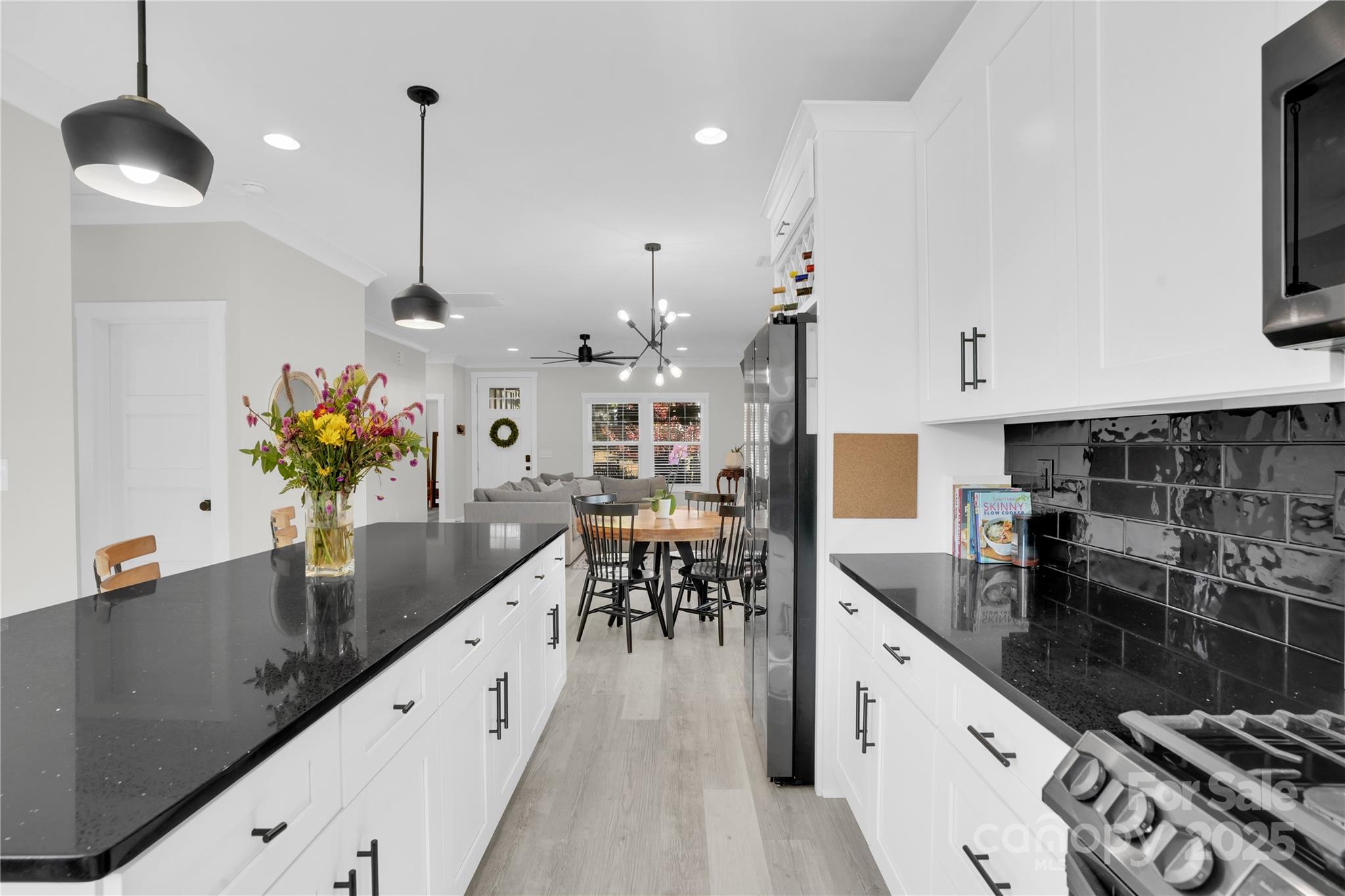 203 A Todd Street Belmont, NC 28012 - Photo 11 of 30 a kitchen with stainless steel appliances kitchen island granite countertop a sink a stove and a wooden floors