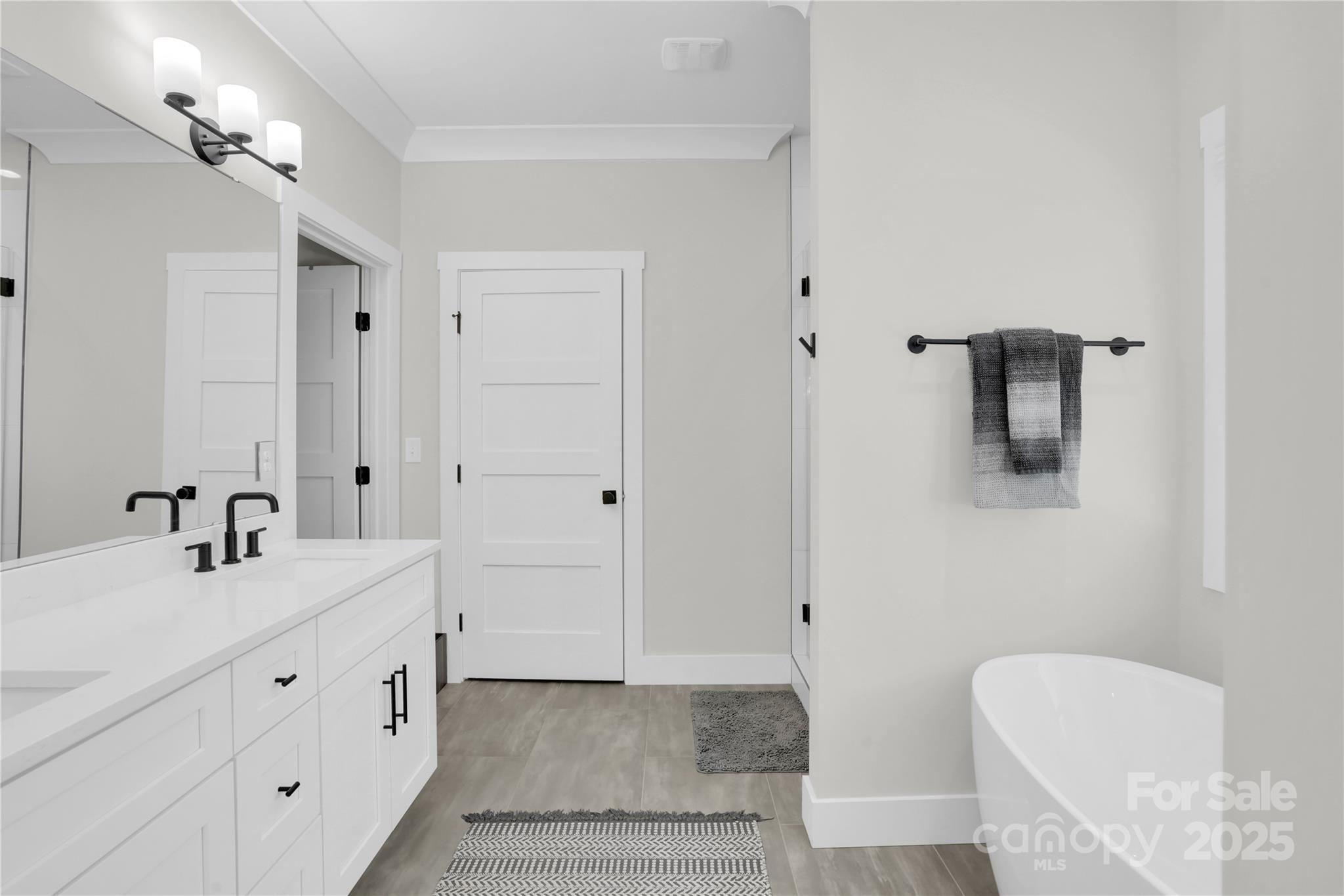 203 A Todd Street Belmont, NC 28012 - Photo 15 of 30 a bathroom with a double vanity sink a mirror and bathtub