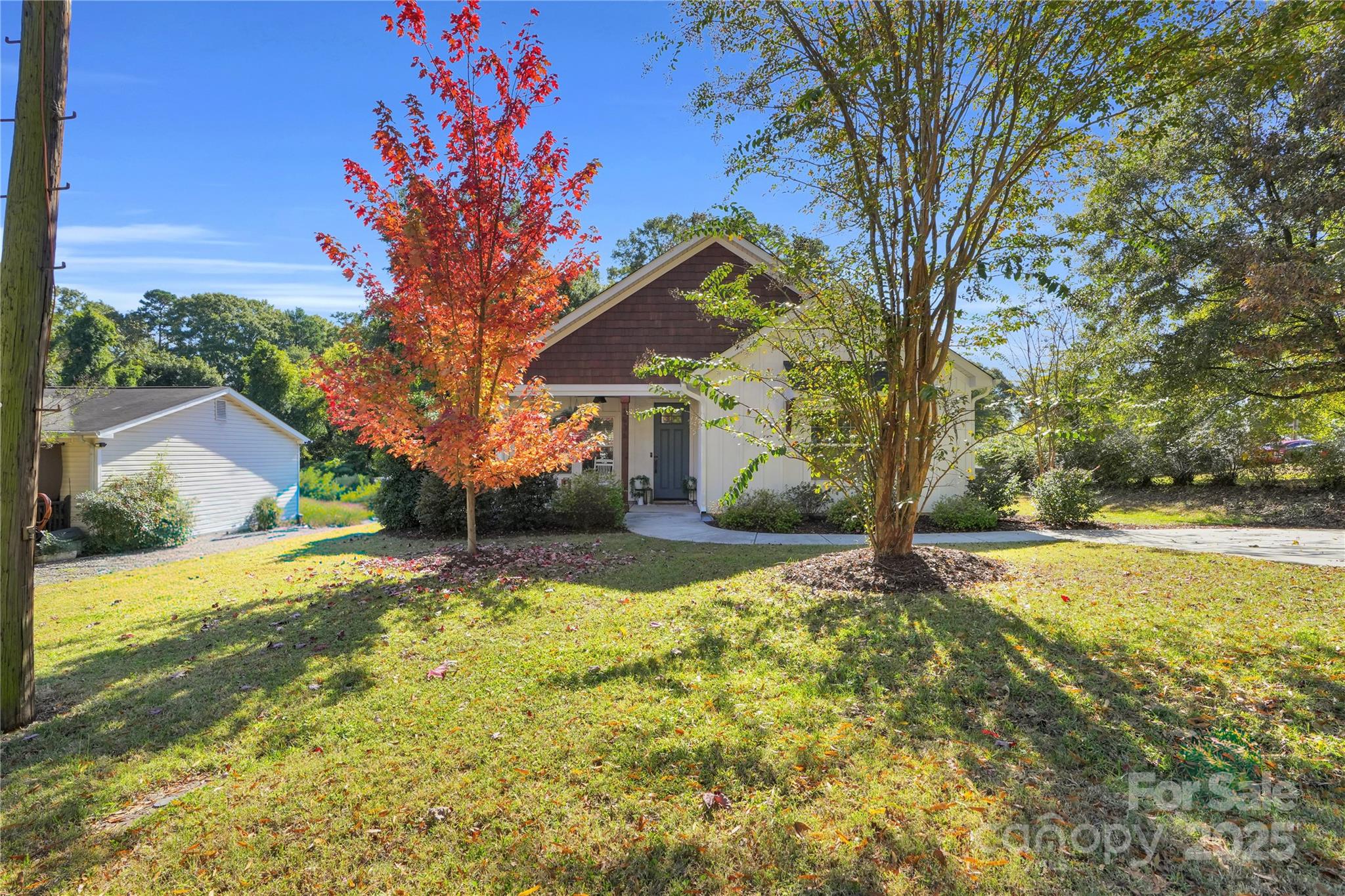 203 A Todd Street Belmont, NC 28012 - Photo 26 of 30 a front view of a house with a yard covered with snow and trees