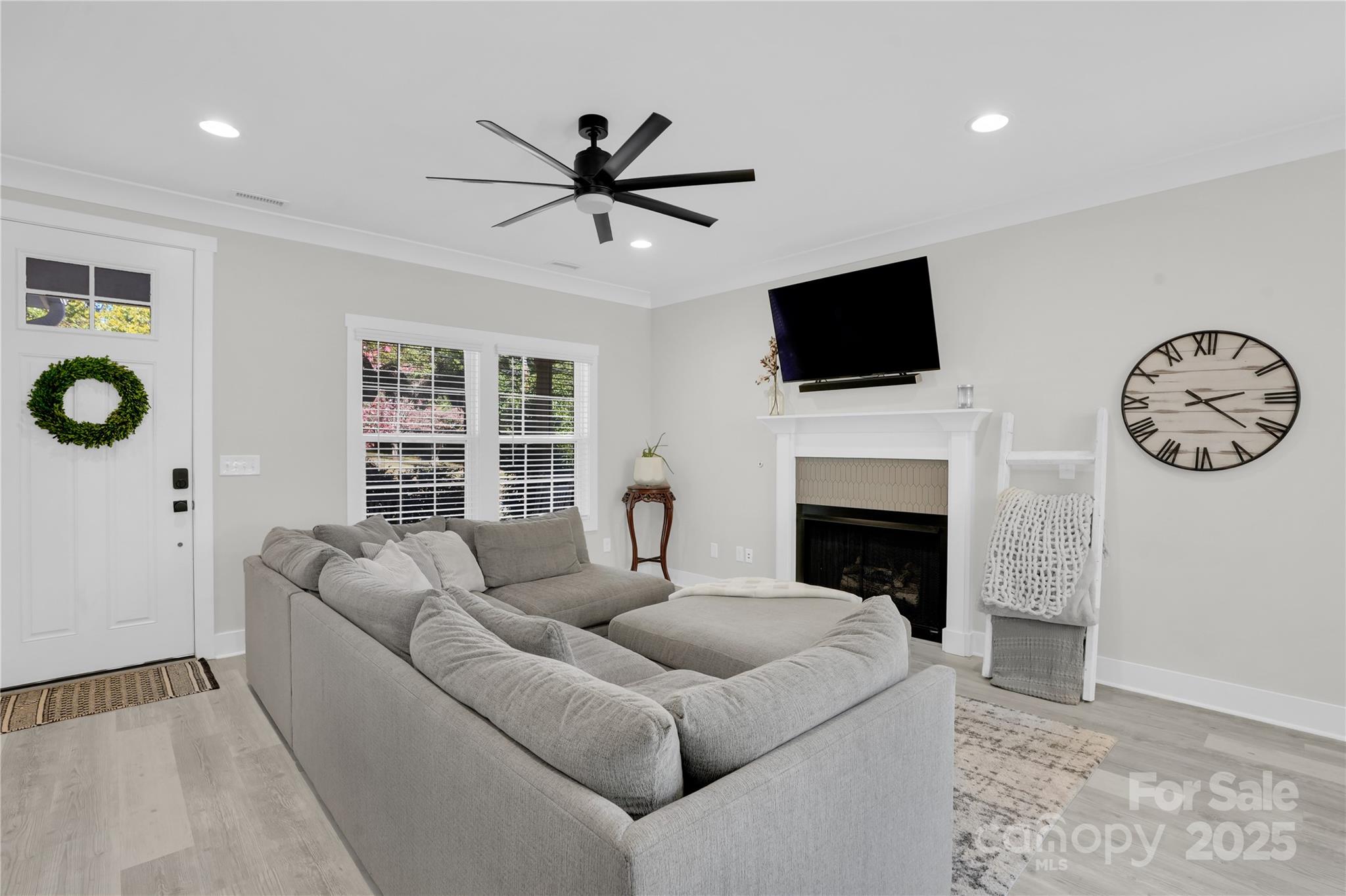 203 A Todd Street Belmont, NC 28012 - Photo 4 of 30 a living room with furniture a fireplace and a flat screen tv