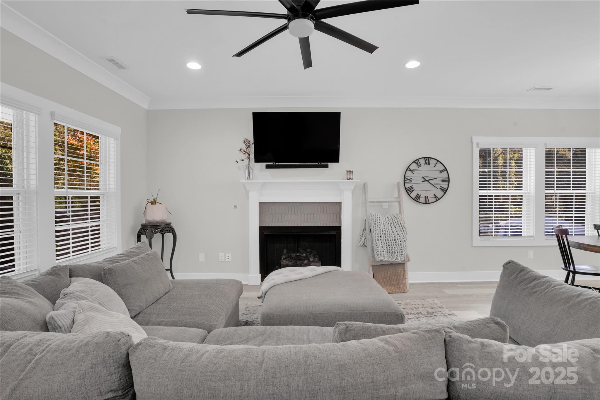 203 A Todd Street Belmont, NC 28012 - Photo 5 of 30 a living room with furniture a flat screen tv and a fireplace