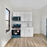 a kitchen with a refrigerator stove and wooden cabinets