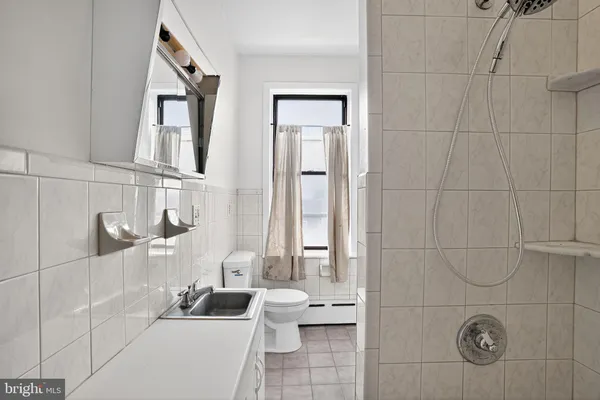 a bathroom with a tub a sink and a shower