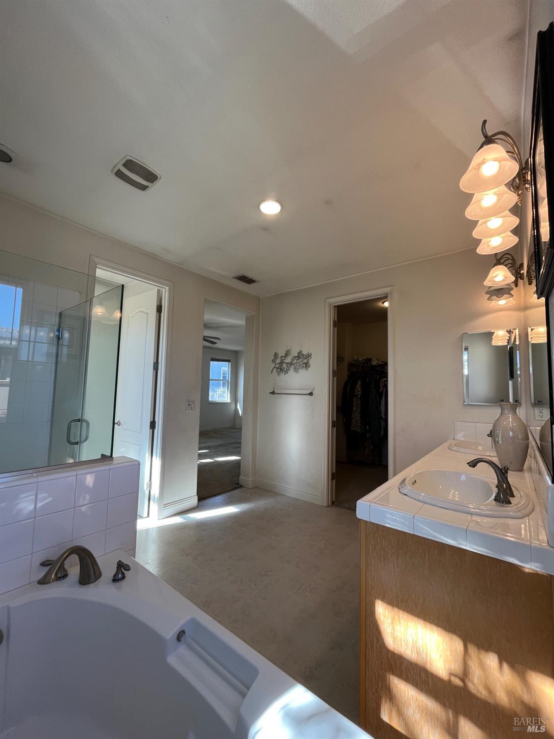 2472 Shorey Way Fairfield, CA 94533 - Photo 36 of 43 a bedroom with a bed and a chandelier