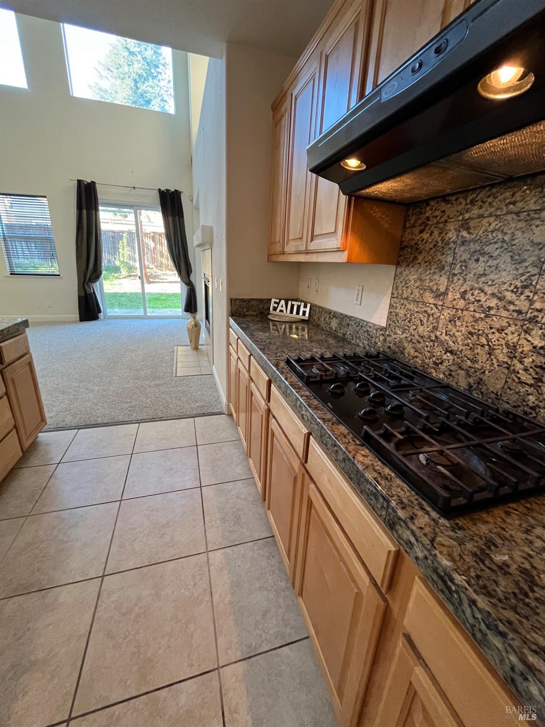 2472 Shorey Way Fairfield, CA 94533 - Photo 9 of 43 a kitchen with granite countertop a stove a sink and a shower