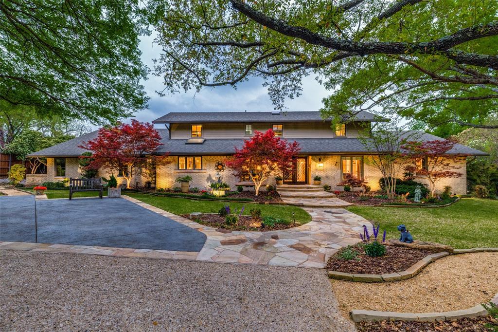 6848 Mossvine Circle Dallas, TX 75254 - Photo 1 of 1 a front view of a house with a yard and garage