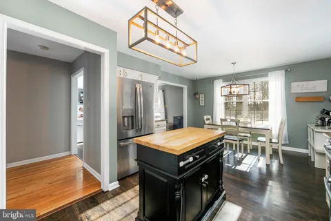 a room with pool table and windows