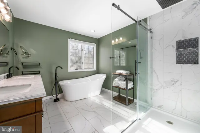 a spacious bathroom with a bathtub shower and sink