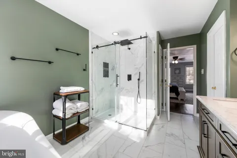 a spacious bathroom with a shower a toilet and a shower