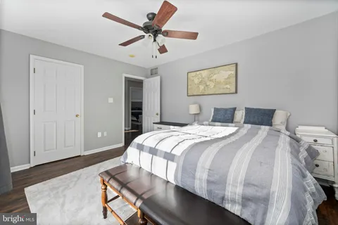 a bedroom with a large bed and a chandelier