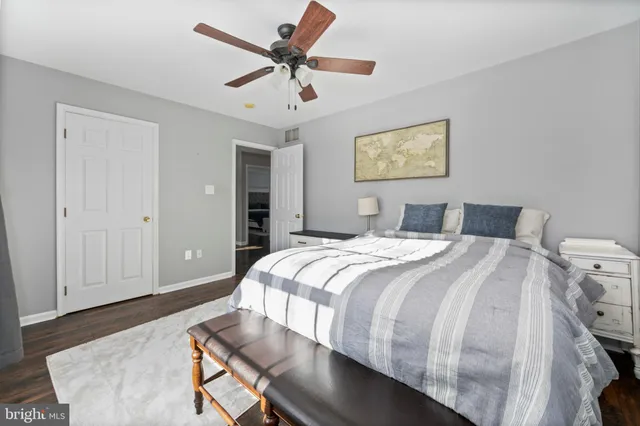 a bedroom with a large bed and a chandelier