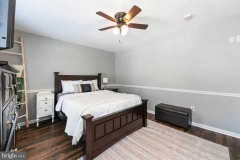 a bedroom with bed and wooden floor