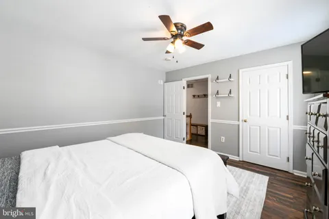 a bedroom with a large bed and a chandelier