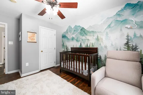 a view of a bedroom with furniture and a chandelier fan