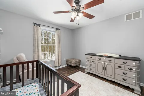 a bedroom with furniture and a window