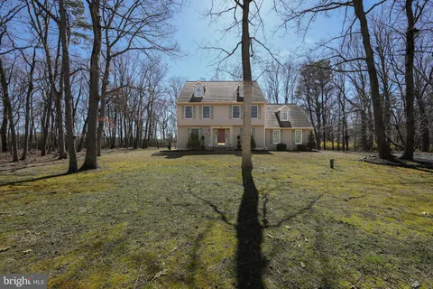 a view of house with yard in front of it