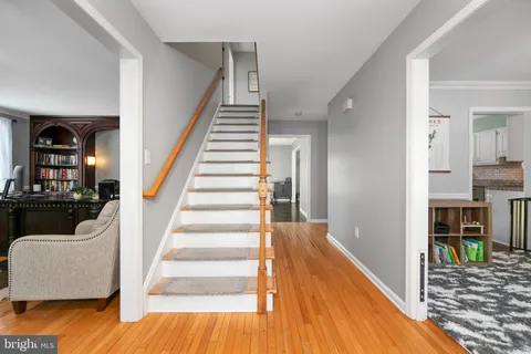 a view of entryway and hall with wooden floor